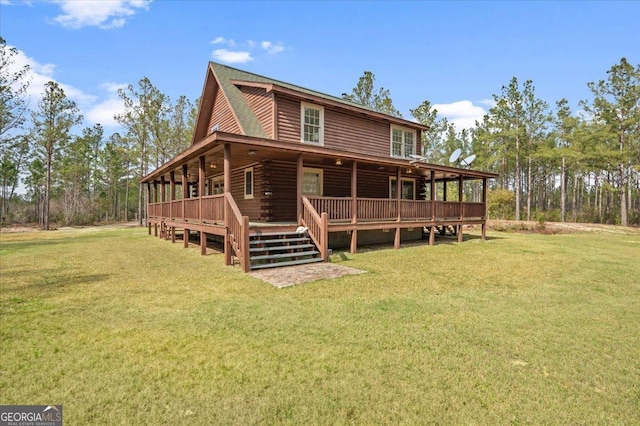 rear view of property with a yard and a deck