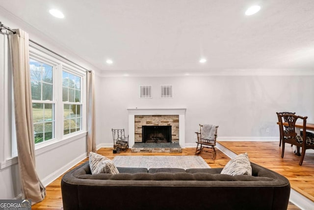 living room with plenty of natural light, a fireplace, and visible vents