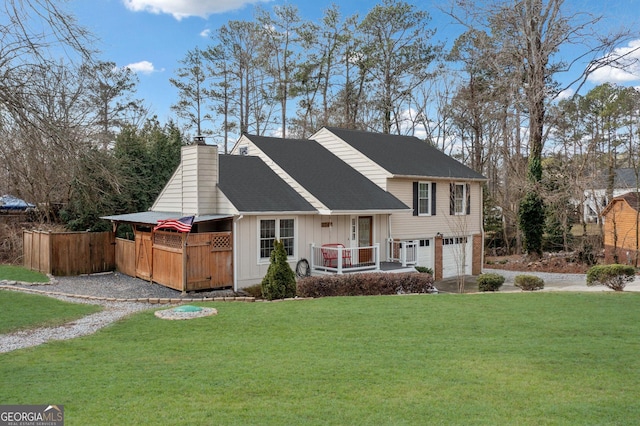 view of front of house featuring an attached garage, fence, a front lawn, board and batten siding, and a chimney