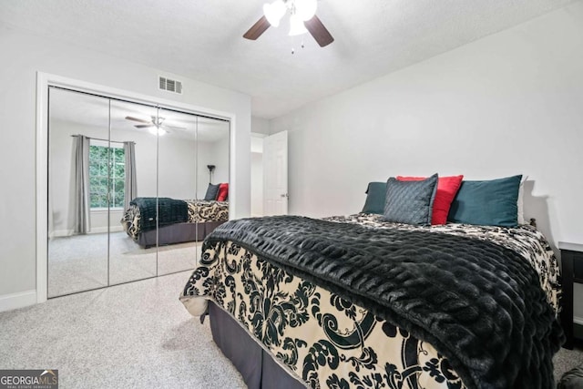 bedroom featuring a closet, visible vents, a ceiling fan, a textured ceiling, and baseboards