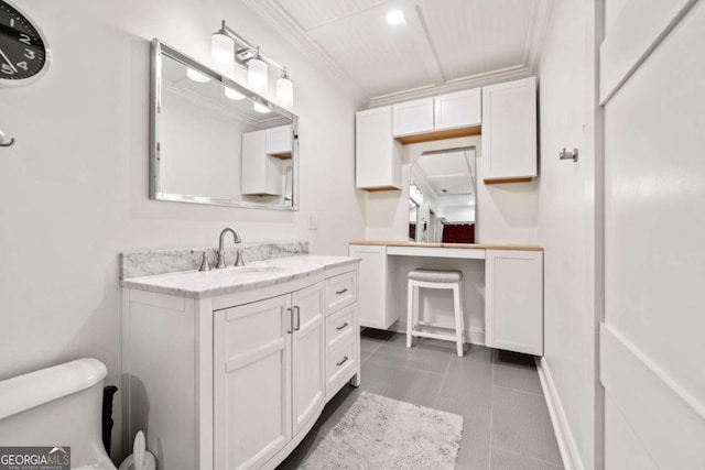 bathroom featuring tile patterned floors, crown molding, and vanity