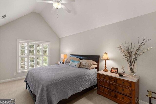 bedroom featuring baseboards, vaulted ceiling, visible vents, ceiling fan, and light colored carpet