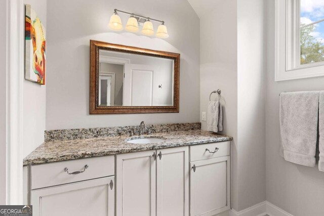 bathroom with vanity and baseboards