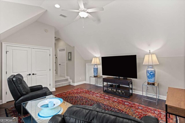 living area with wood finished floors, ceiling fan, baseboards, and vaulted ceiling