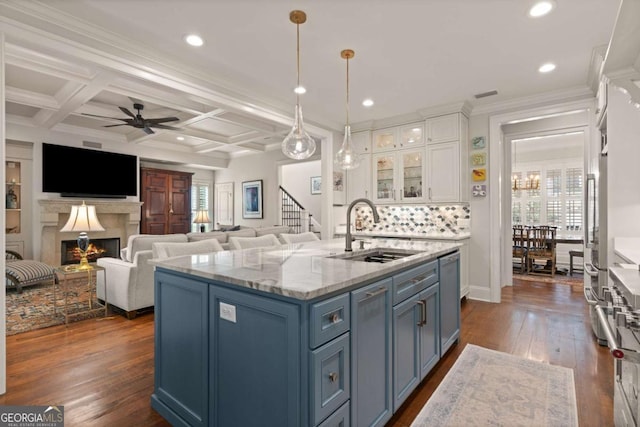kitchen featuring a sink, dark wood finished floors, white cabinetry, and a ceiling fan