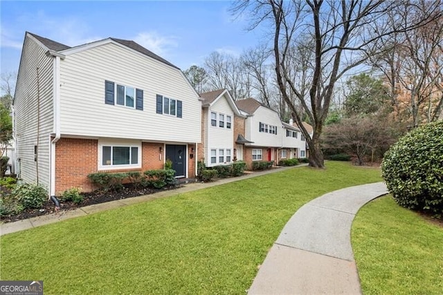 view of front of property featuring brick siding and a front lawn