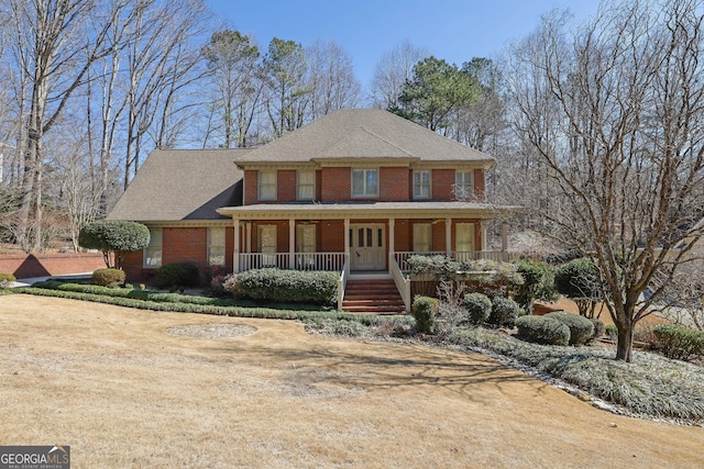 view of front of house featuring covered porch and brick siding