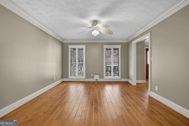 unfurnished room featuring baseboards, light wood-style flooring, ceiling fan, ornamental molding, and a textured ceiling