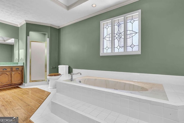 bathroom with toilet, vanity, ornamental molding, a bath, and a stall shower