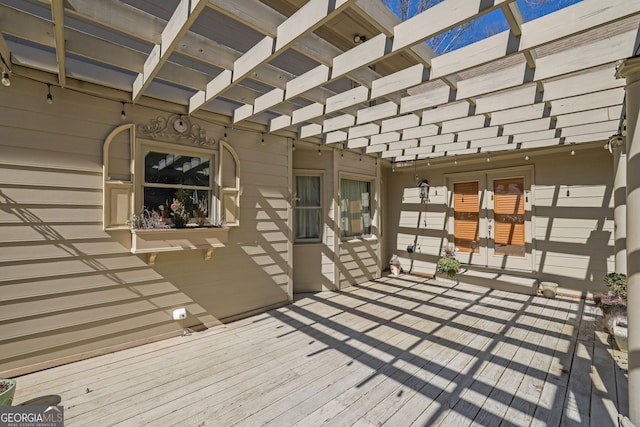 wooden terrace featuring french doors and a pergola