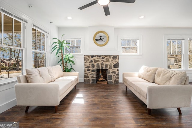 living room featuring dark wood finished floors, a fireplace, plenty of natural light, and recessed lighting