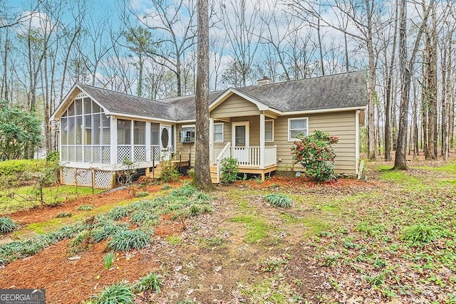 view of front of home featuring a sunroom