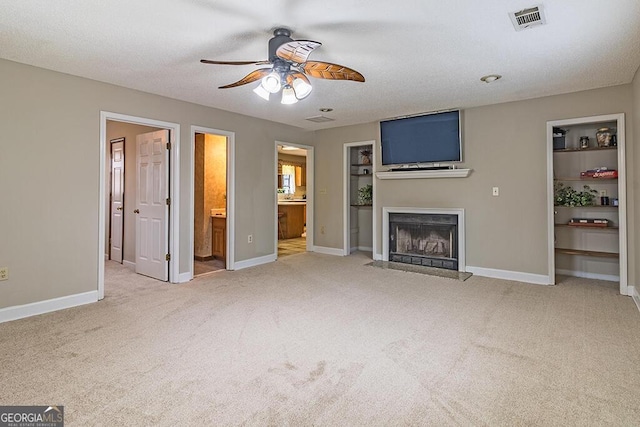 unfurnished living room with light carpet and ceiling fan