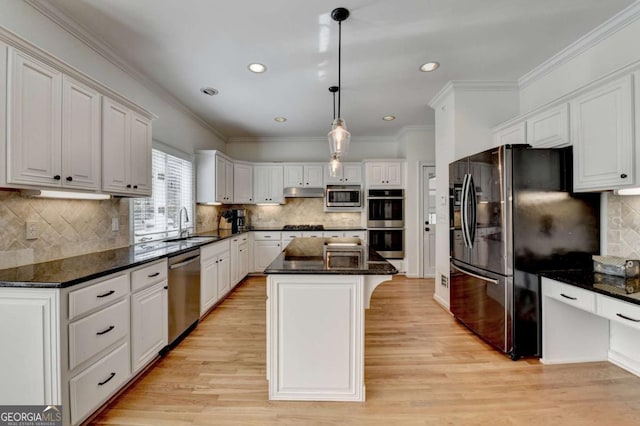 kitchen with white cabinets, stainless steel appliances, and a center island