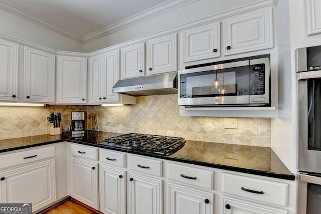 kitchen with white cabinets, under cabinet range hood, ornamental molding, and stainless steel appliances