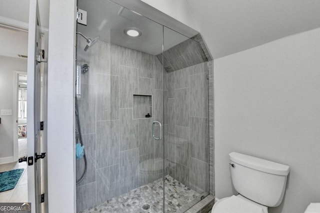 full bath featuring toilet, a stall shower, baseboards, and ensuite bathroom