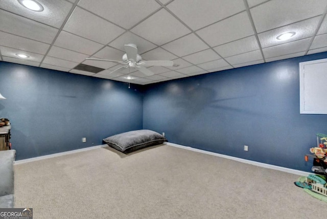 unfurnished bedroom featuring carpet flooring, a paneled ceiling, and baseboards