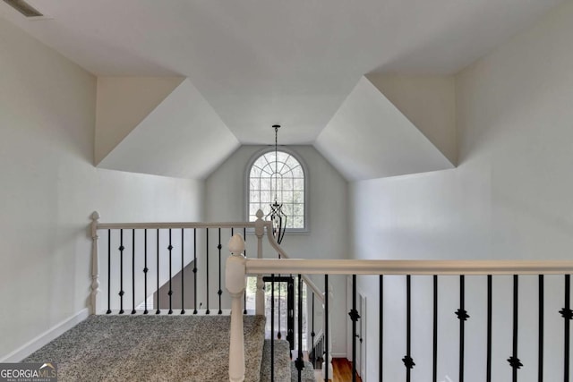 stairs with vaulted ceiling, carpet floors, visible vents, and baseboards