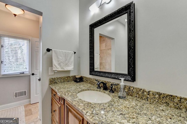 bathroom with vanity, visible vents, and baseboards