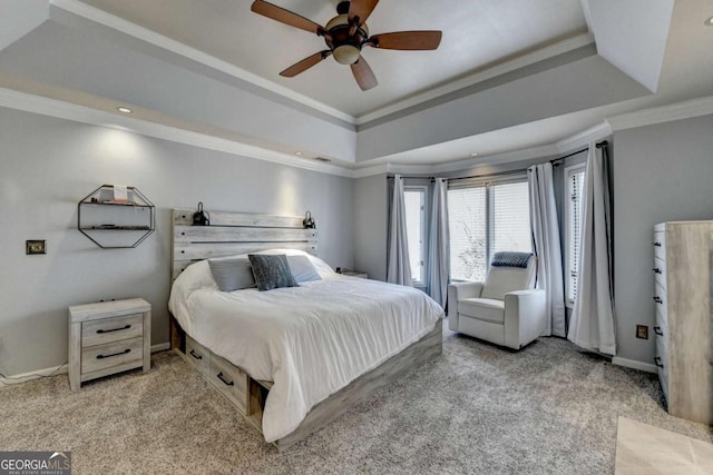 bedroom with a tray ceiling, light colored carpet, crown molding, and baseboards