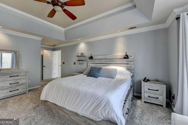 bedroom with a raised ceiling, visible vents, baseboards, and carpet flooring