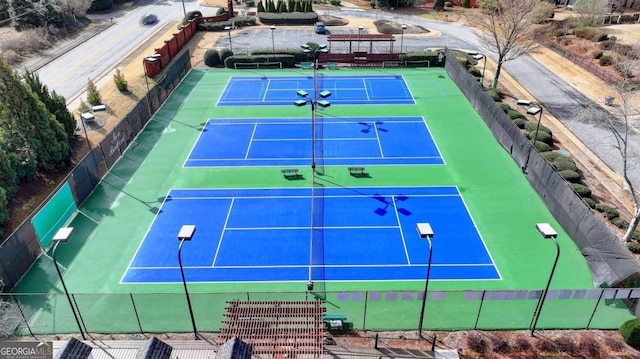 view of tennis court featuring fence