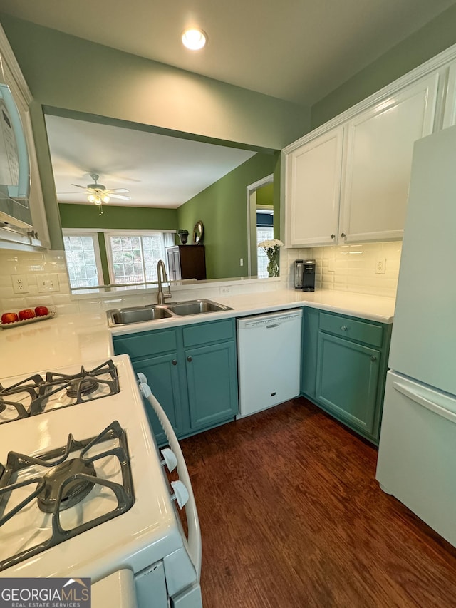 kitchen with white appliances, tasteful backsplash, dark wood-style flooring, light countertops, and a sink