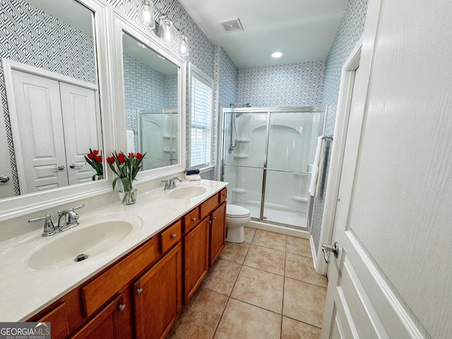 bathroom with tile patterned floors, visible vents, a sink, and wallpapered walls