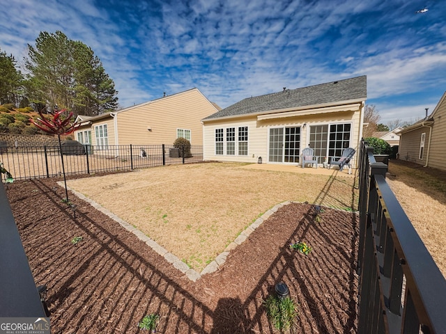 back of property featuring a patio area, a fenced backyard, and a lawn