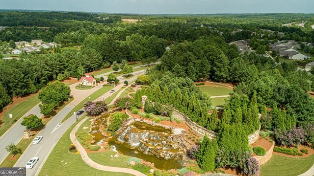 drone / aerial view with a wooded view