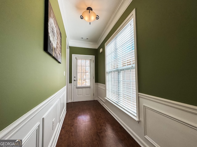 entryway with wainscoting, wood finished floors, visible vents, and crown molding