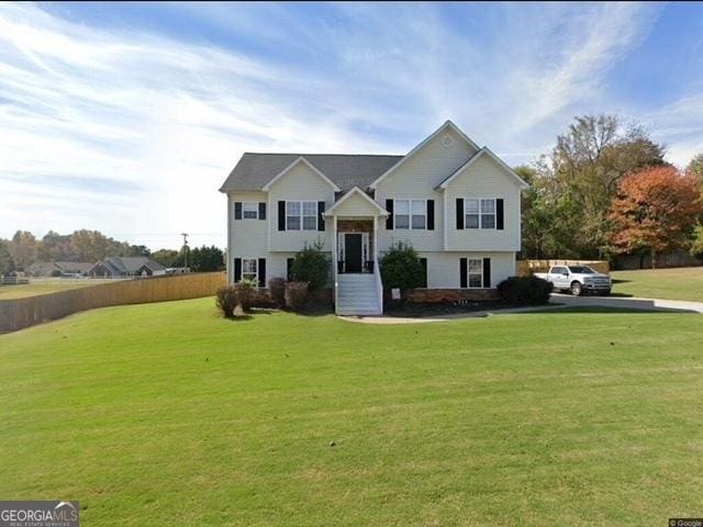 bi-level home with a front lawn