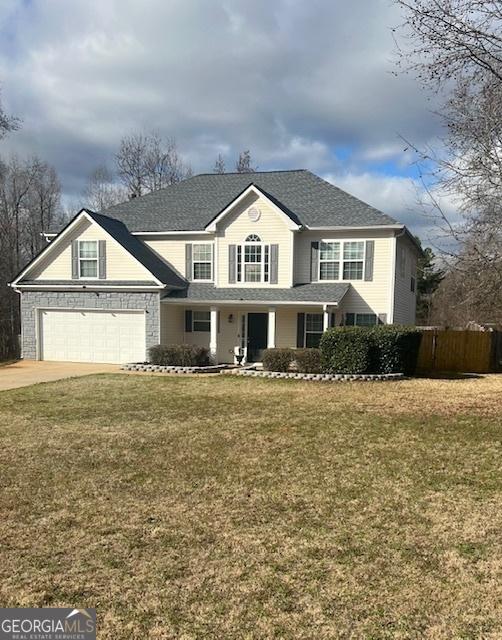 view of front property featuring a front lawn and a garage