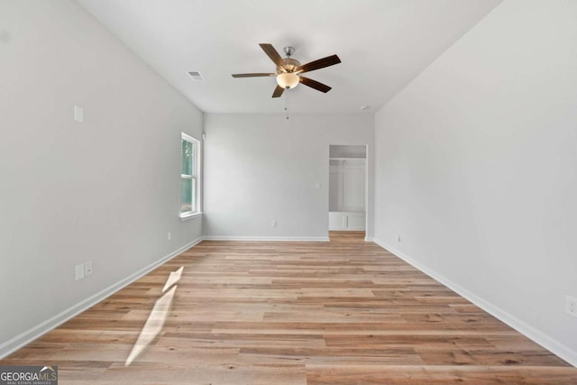 spare room featuring ceiling fan and light hardwood / wood-style flooring