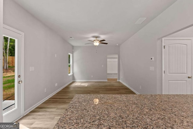 unfurnished living room featuring ceiling fan and light hardwood / wood-style floors