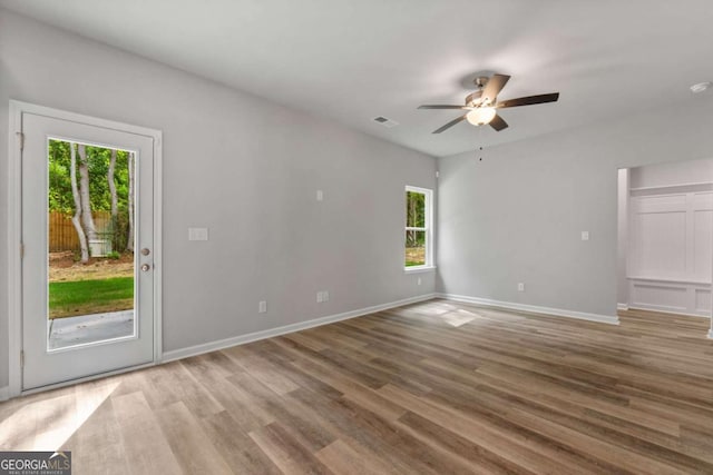 spare room with ceiling fan and wood-type flooring