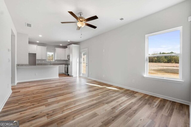 65 Patterson Dr, Franklin, GA 30217 - unfurnished living room featuring a ceiling fan, light wood-style floors, baseboards, and recessed lighting