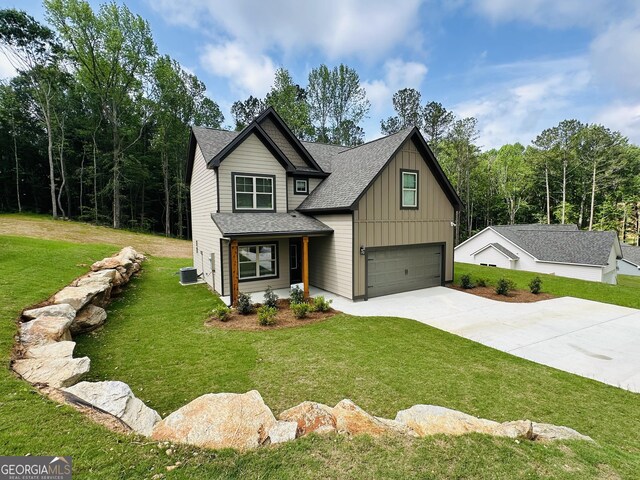 65 Patterson Dr, Franklin, GA 30217 - view of front facade with board and batten siding, an attached garage, concrete driveway, cooling unit, and a front lawn
