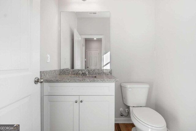 65 Patterson Dr, Franklin, GA 30217 - half bath with toilet, vanity, wood finished floors, and baseboards