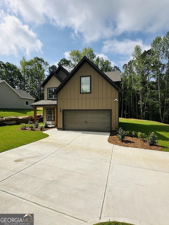 65 Patterson Dr, Franklin, GA 30217 - view of front facade with board and batten siding, a front lawn, concrete driveway, and an attached garage