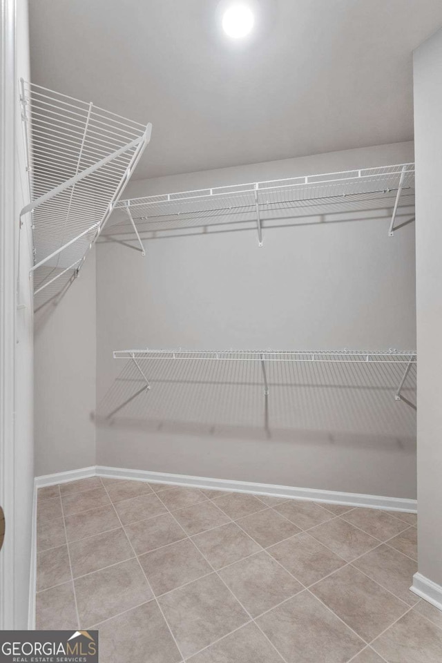 spacious closet featuring light tile patterned floors