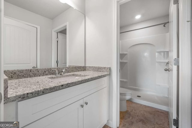 bathroom with vanity, tile patterned floors, and a shower