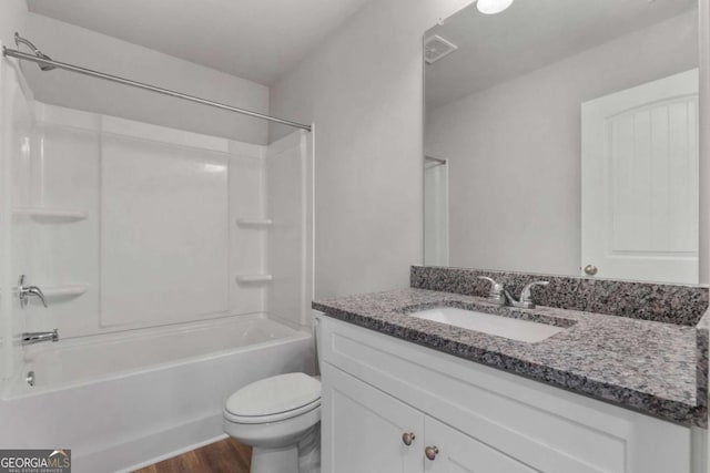 full bathroom with shower / bath combination, vanity, hardwood / wood-style floors, and toilet