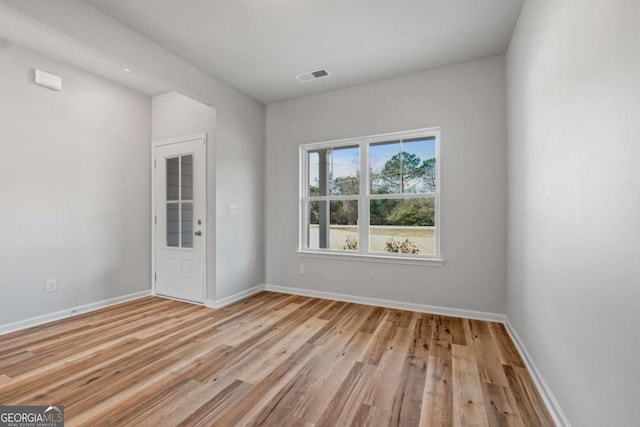 spare room with light hardwood / wood-style flooring