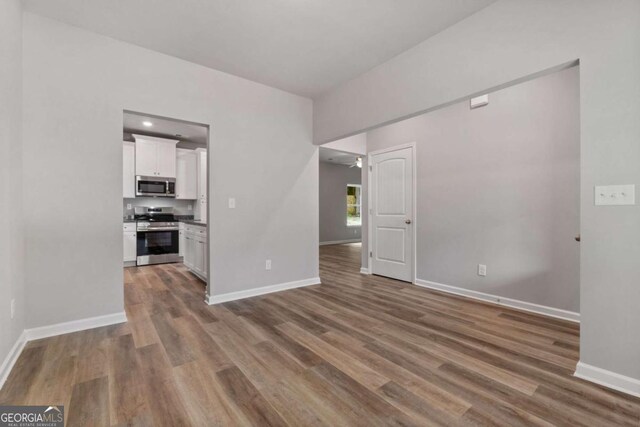 65 Patterson Dr, Franklin, GA 30217 - unfurnished living room with baseboards and wood finished floors