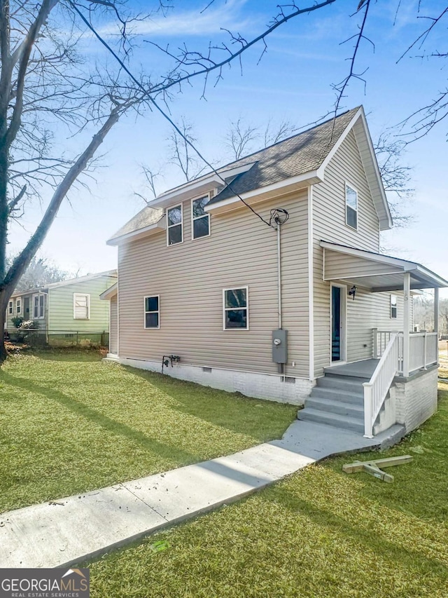 view of home's exterior featuring covered porch, a yard, crawl space, and roof with shingles