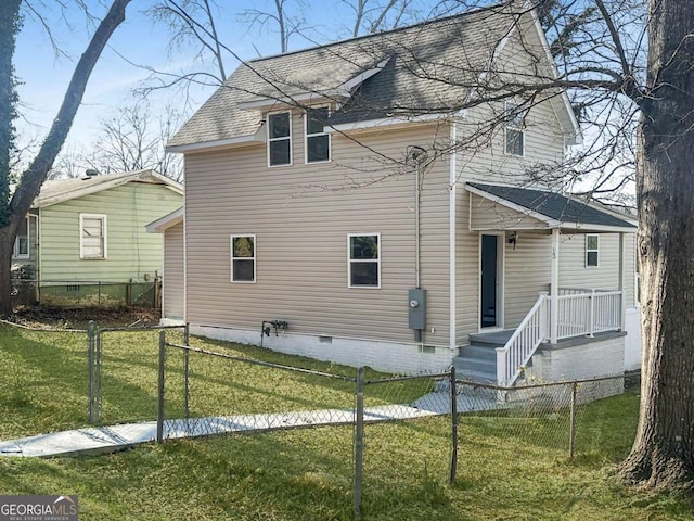 back of property featuring a shingled roof, fence private yard, crawl space, and a yard