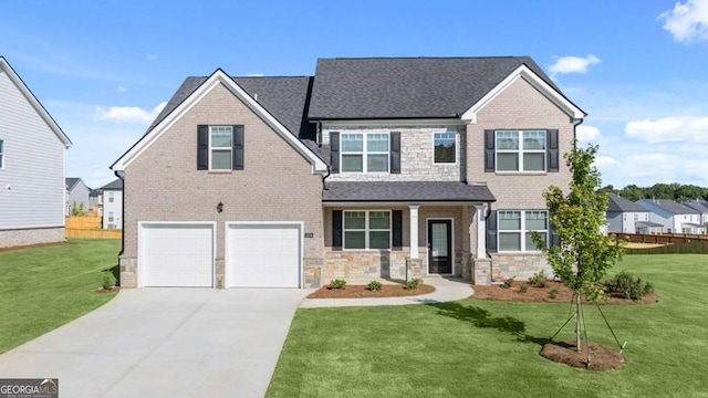 view of front of house featuring a garage, a front yard, and covered porch