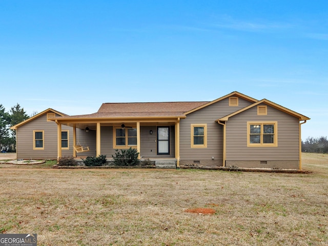 ranch-style home with a front yard, ceiling fan, and covered porch