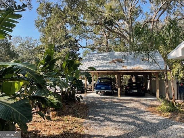 view of vehicle parking with a carport